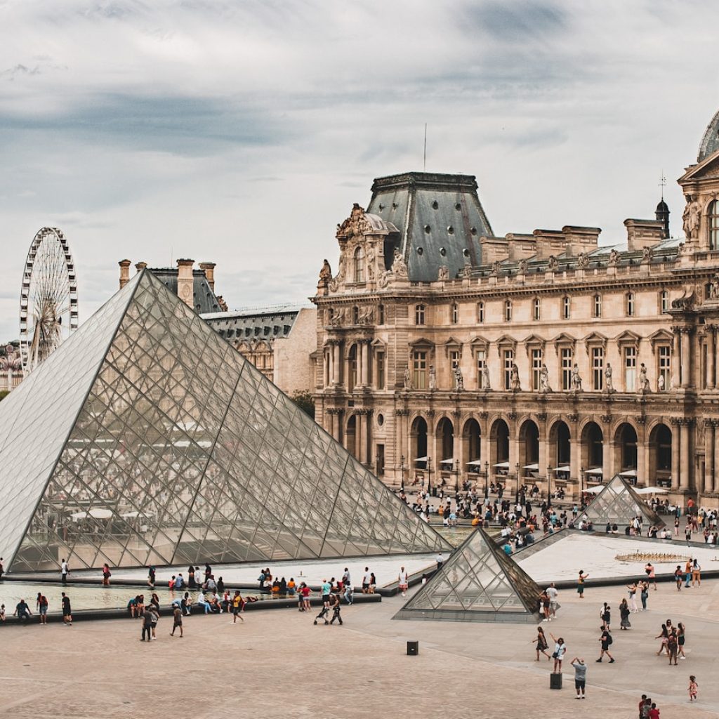 people gathering near Louvre Museum during daytime