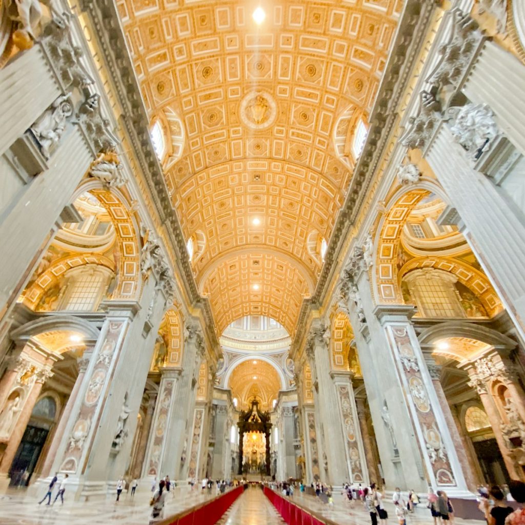 the ceiling of a large building with a red carpet