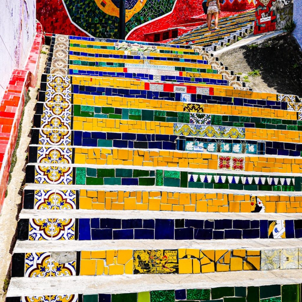 a colorful wall with a person standing on it
