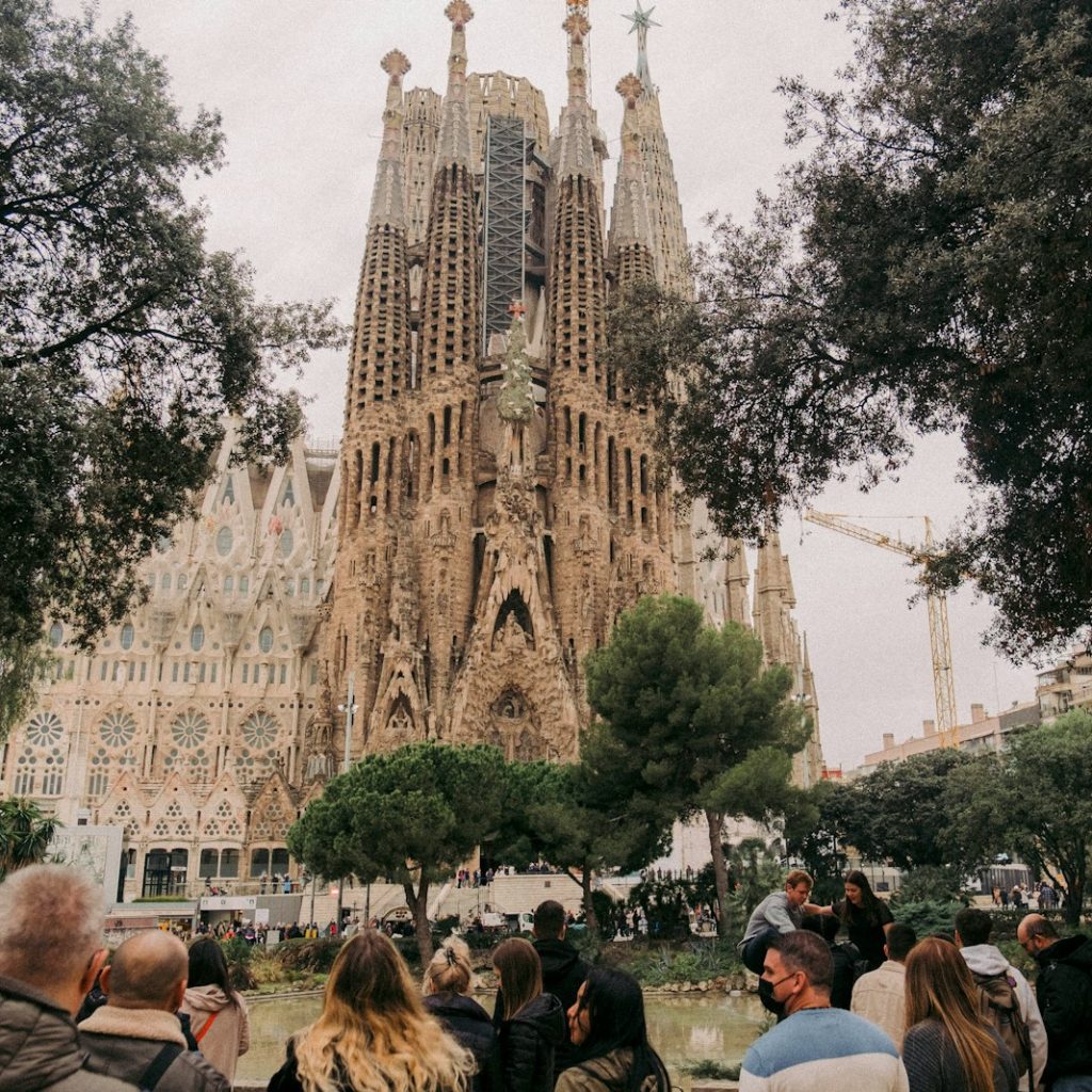 a crowd of people walking in front of a castle